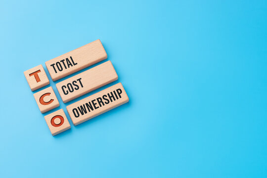 Total cost ownership concept with wooden blocks and TCO abbreviation