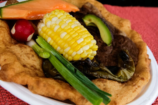Traditional Navajo taco with corn and green chile.on fry bread 