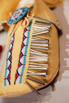 Beaded moccasin with metal cone detail close up
