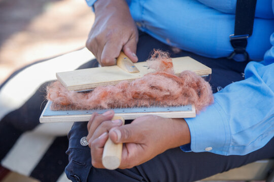 Preparing wool for traditional Navajo weaving