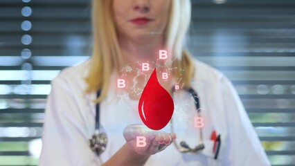 Doctor holds Holographic Red Blood Drop With B Symbols And Molecular Graphics © TechAnimationStock
