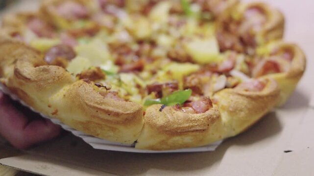 Extreme macro shot of a delicious Hawaiian pizza with golden melted cheese, ham slices, and pineapple. Featuring a decorative stuffed crust and shallow depth of field for a professional look.