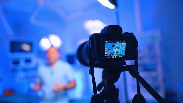 Display of camera with a male medic in blue uniform. Close up. Healthcare blog footage in surgery room.