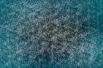 Obraz premium Abstract teal particle background with dense white speckle resembling snow or stars, creating a textured, festive and cosmic atmosphere suitable for winter, holiday, celebration, or science