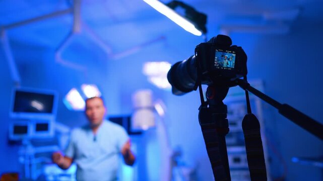 Working camera directed on the male medic. Low angle view. Healthcare blog concept.
