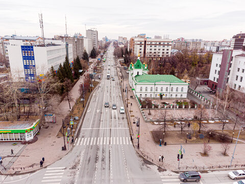 Drone shot captured with DJI Mini 2 overlooking Republic Street (Ulitsa Respubliki) in Tyumen, Russia, spanning the segment from Ordzhonikidze Street to Profsoyuznaya Street. On the left side of the