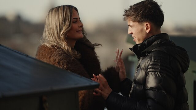 A young couple in Paris France share a romantic moment outdoors The image captures their love and affection in an urban setting perfect for travel and relationship themes.