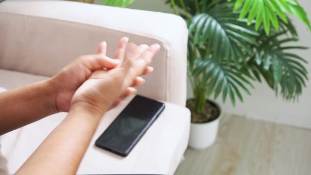 Close-up of female hand massaging pain palm and wrist due to carpal tunnel syndrome. Concept of muscle strain, numbness, and trigger finger caused by smartphone overuse and poor ergonomics