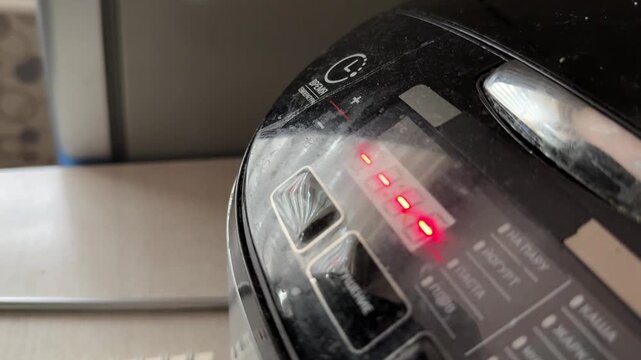 Multicooker switching modes on digital display close up at home, changing program settings, kitchen appliance interface, cooking process concept