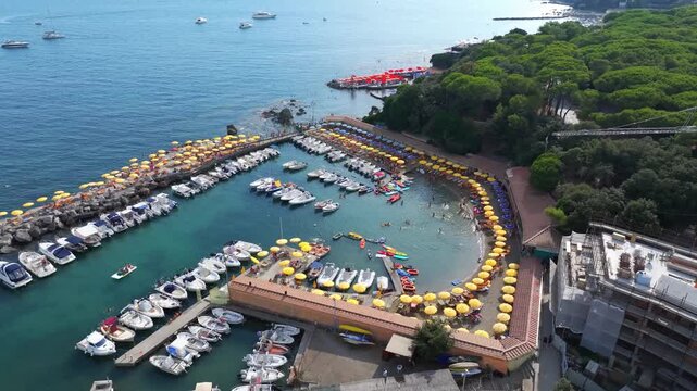 beach, motorboats, pleasure craft and yellow umbrellas, resort atmosphere, Castiglioncello, Italy