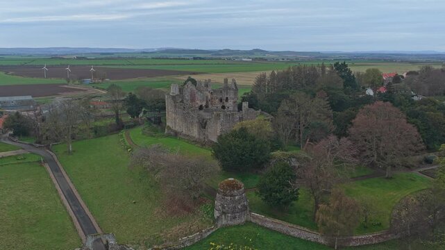 Majestic aerial view of the historic dirleton castle, a medieval fortress in east lothian, scotland, surrounded by lush green gardens