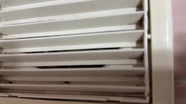 bathroom exhaust fan grille in close up, ventilation system removing humid air and odors, home air circulation concept