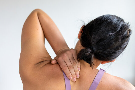 Woman relieving shoulder pain.