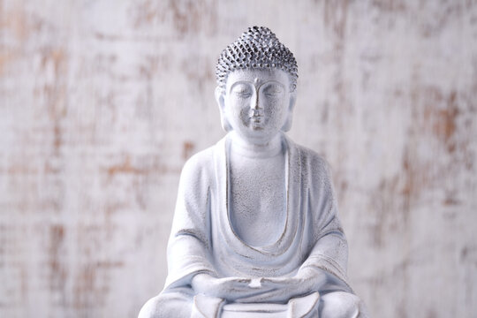 Meditating Buddha Statue on wooden background. Soft focus. Close up. Copy space