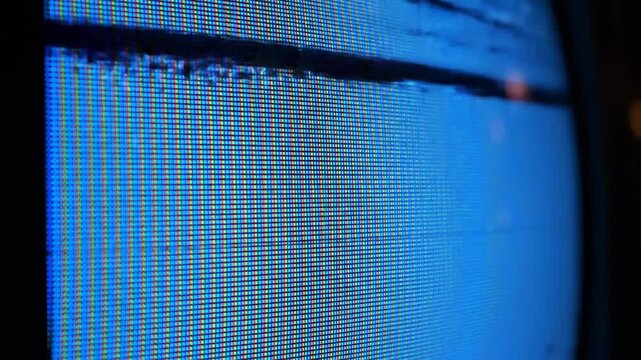 Macro View of CRT Television Screen with Blue Static Glitch and RGB Pixel Grid
