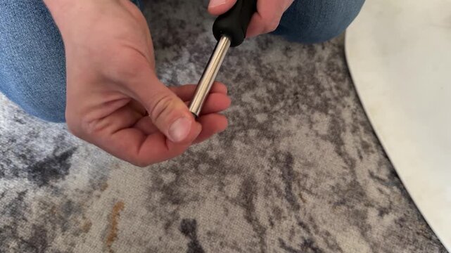 man attaching screwdriver bit to screwdriver at home, tool preparation, repair setup, maintenance task, everyday work