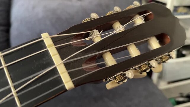 Close up of acoustic guitar body with metal grid background, music instrument detail, abstract composition with texture and shallow depth of field