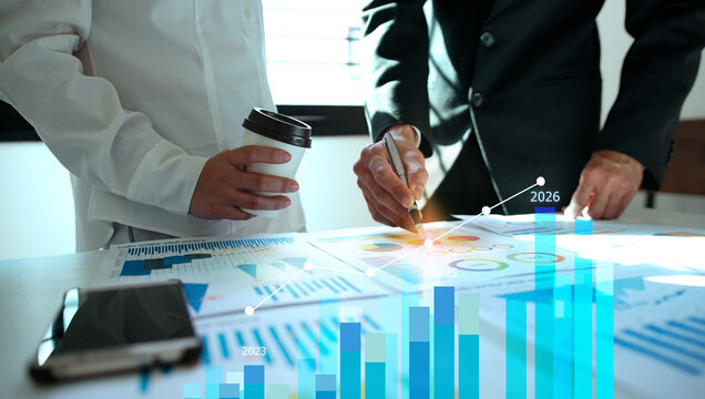 Businessman reviewing balance sheet and virtual data charts. financial analysis concept, strategy planning and growth opportunities, calculating company investment