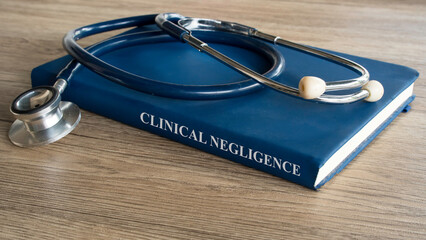 Clinical Negligence concept featuring a medical law textbook with a professional stethoscope on a...