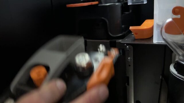 Hand installing brewing unit latch into coffee vending machine, fitting brew group inside automatic beverage equipment, technical maintenance concept