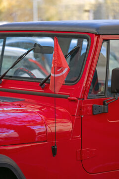 Red Smiley Flag at Top of Radio Antenna All Terrain Vehicle Suv