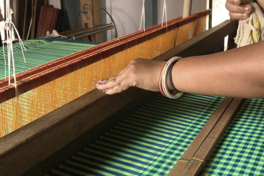 Handloom weaver in India working in loom.