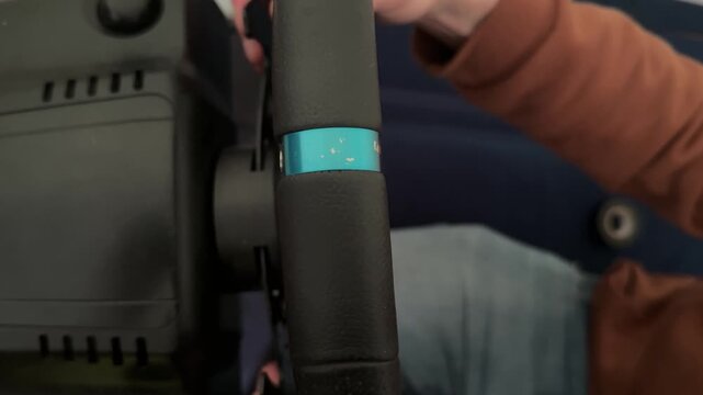 Finger pressing button on racing simulator steering wheel controller, gaming equipment and computer driving concept