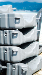 Fototapeta premium A stack of gray modular plastic floating dock sections in a harbor area
