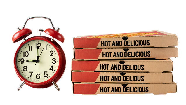 Isolated red alarm clock standing beside a stack of hot and delicious pizza boxes
