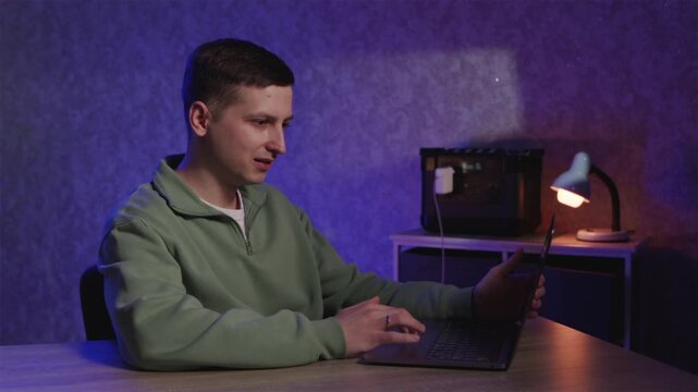 Man working on laptop during power outage using portable power station