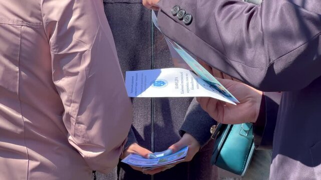 Promoter handing out advertising flyers on the street