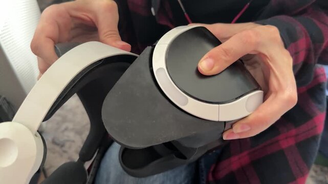 Hands adjusting VR headset position close up, virtual reality device setup and immersive technology concept