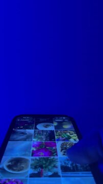 Hand holding and scrolling smartphone video
