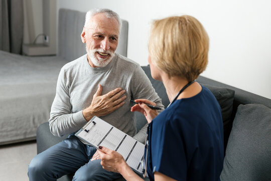 Health care professional visits senior man at home for consultation and support