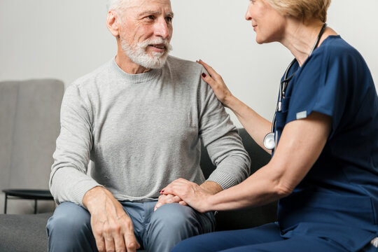 Doctor visits senior man at home for medical consultation and support