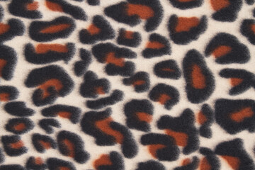 Orange and black leopard spot fabric background © Karen Roach