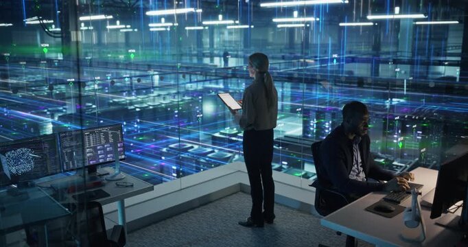 Technology Specialists Activate Information Flows in a Futuristic Data Center, Monitoring Servers, AI Analytics, Cloud Systems, Network Visualization Across Digital Infrastructure. Elevated Shot