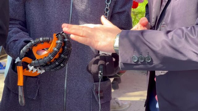 Person demonstrating a robotic glove for hand rehabilitation