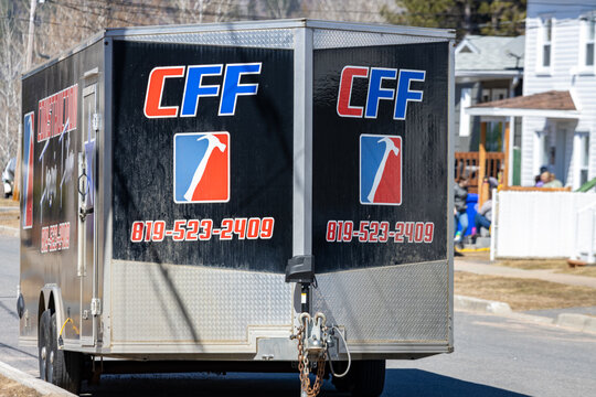Quebec, Canada, 26 April 2026 : A utility trailer with the CFF logo and a hammer graphic is parked on a residential street.