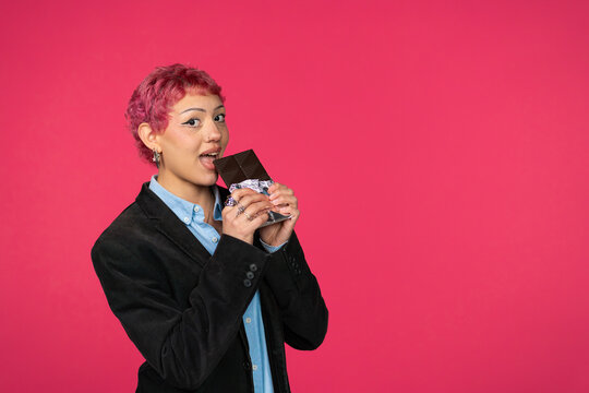 Young person enjoying dark chocolate bar