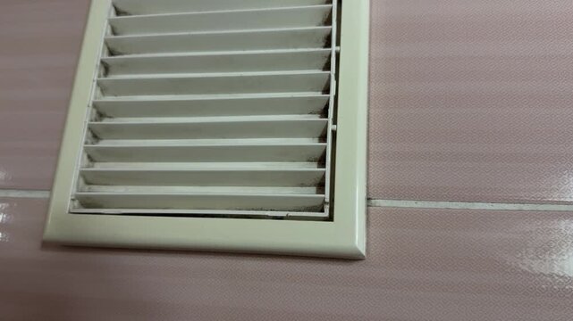 bathroom exhaust fan grille in close up, ventilation system removing humid air and odors, home air circulation concept