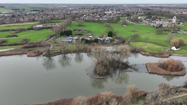 Aerial Drone Flight Over Wicksteed Park Lake and Lakeside Cottages in Kettering UK