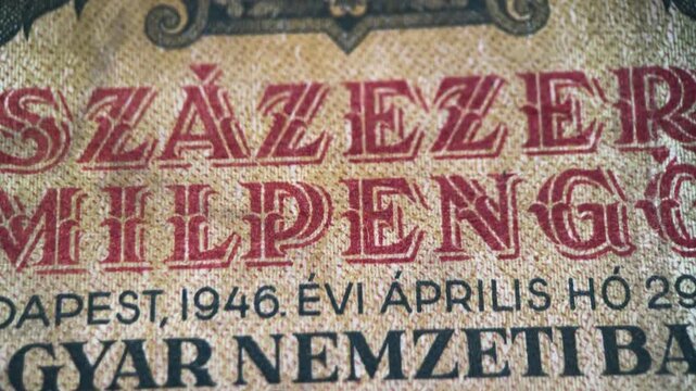 etailed macro video featuring the design and paper texture of an old Hungarian pengo banknote. The footage highlights printed numerals, signatures, ornamental engraving, and aged surface details.