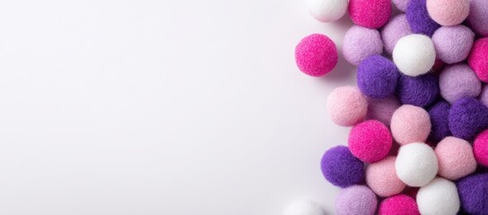 Obraz premium Pile of fluffy pom-poms in white, pink, purple hues on white surface, right side