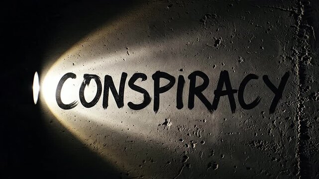 Flashlight Illuminates the Word Conspiracy on a Textured Wall