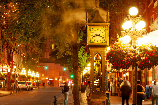 Famous steam-powered clock at the corner of Water Street and Cambie Street,  surrounded by night life in Gastown oldest neighborhood of Vancouver, Canada