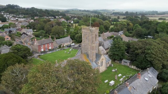 Aerial Drone View of St Mary's Church and Quaint Village of Burton Bradstock Dorset England UK