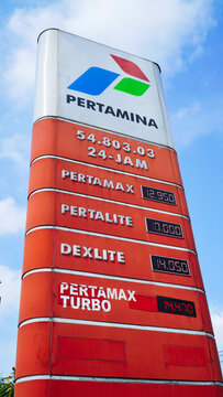 Pertamina gas station in Bali. Gasoline prices in 2024.Gas station sign shows fuel prices in Indonesia during the day with clear skies in the background