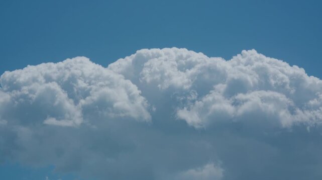 Thick wall of cumulus clouds moving in sky
