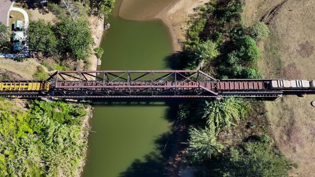 Aerial downward video of a freight train travelling through rural countryside in New South Wales Australia.